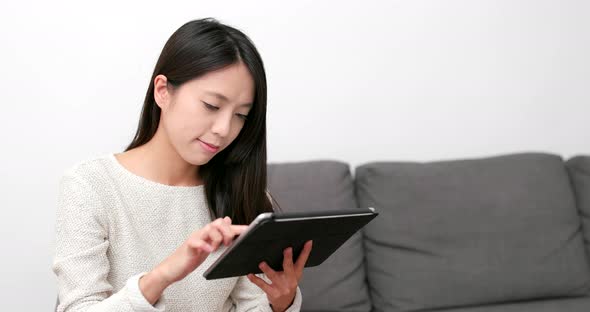 Woman use of digital tablet computer at home