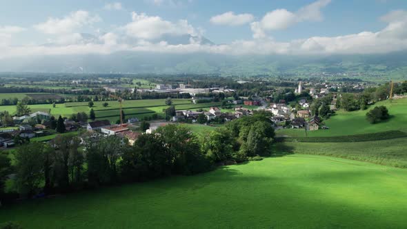 Aerial View of Liechtenstein with Houses on Green Fields in Alps Mountain Valley