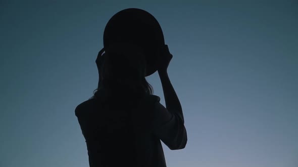 Girl Wears a Hat on the Sky Background