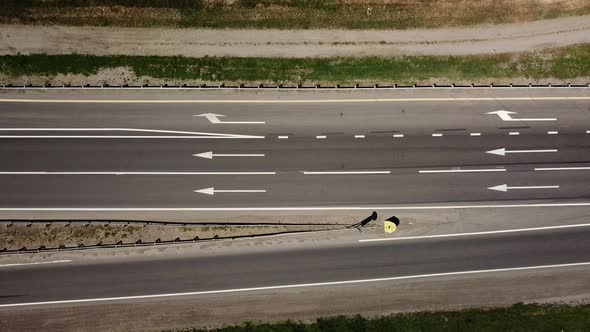 Directly Above Close Up of Road, Asphalt, White Arrow Signs Indicating Direction, Way of the Highway