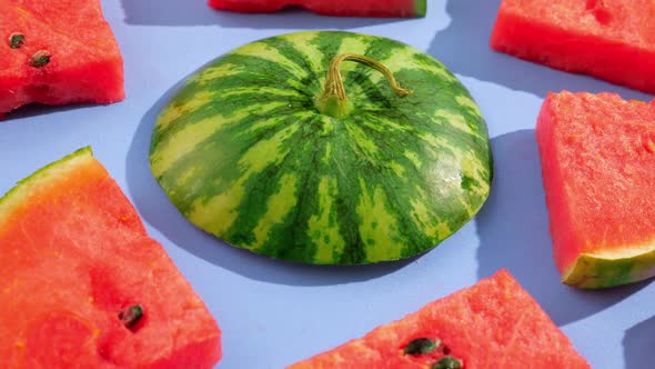 Fresh ripe watermelon slices on blue background.