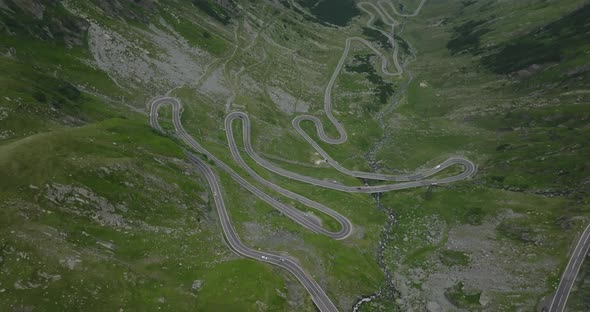 aerial view of part of winding transfagarasan road with moving cars