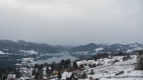 Timelapse of snow flakes falling over a village