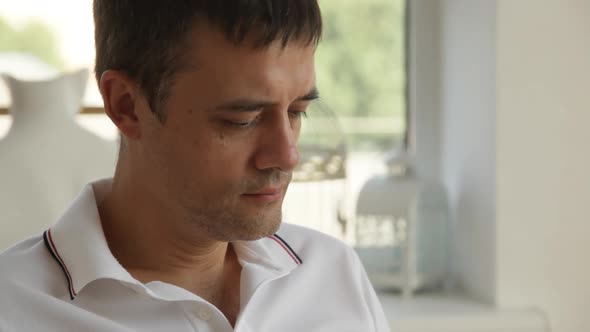 A man is intently reading a book and smiling, close-up.