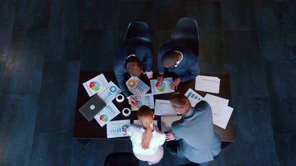 Business people in suits working on a project at a table