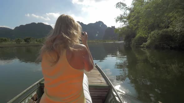 View of Blond Woman with Camera on the Boat. Excursion in Halong Bay, Boat Island Tours. Hanoi