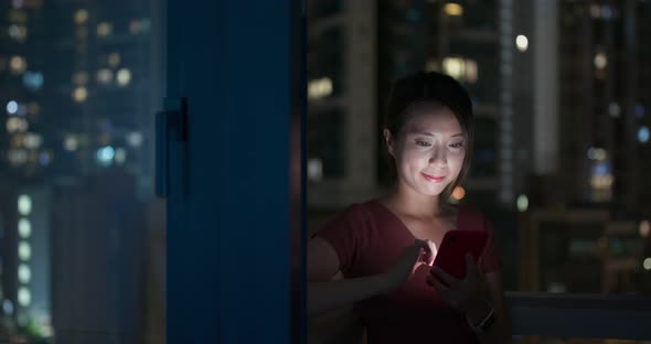 Woman work on mobile phone with building background in city