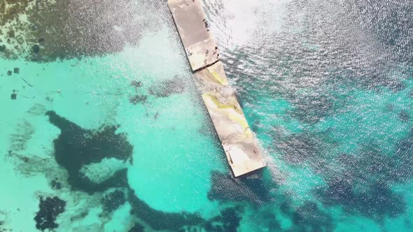 Bird's-eye view of pier extending over Turquoise Mediterranean Sea in Anchor Bay near Popeye Village