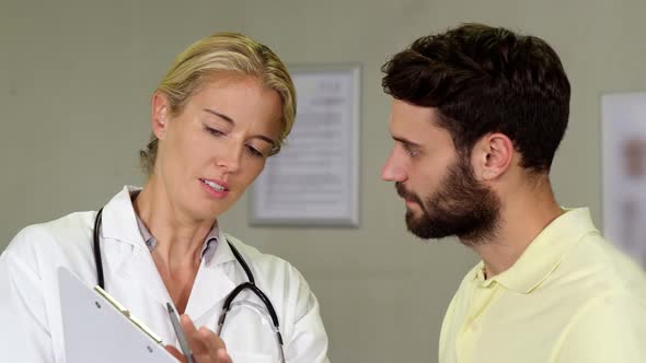Physiotherapist discussing a medical report with patient