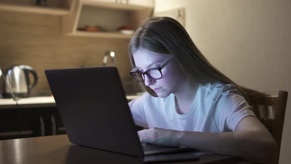 Young Girl Yawns and Falls Asleep While Working at the Computer, Overtime Work