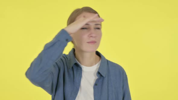 Young Woman Looking Around Searching Yellow Screen