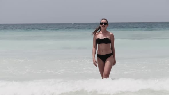 Young Woman in a Bikini Posing on Exotic Beach at the Turquoise Ocean Zanzibar