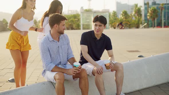 Two Happy Diverse Couples Meeting on Embankment in Summertime