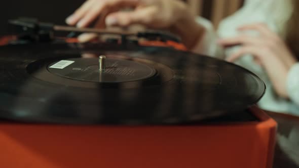 Hand Adjusts the Head Old Record Player Vinyl Discs at Home