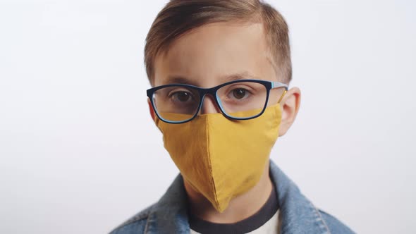 Portrait of Little Boy in Face Mask on White Background