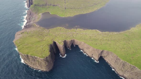 Aerial view of tourists English Slave cliff on North Atlantic sea, Faroe island.