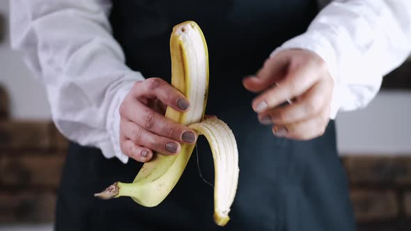 The Chef Is Peeling a Banana From a Skin