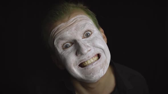 Clown Halloween Man Portrait. Close-up of an Evil Clowns Face. White Face Makeup