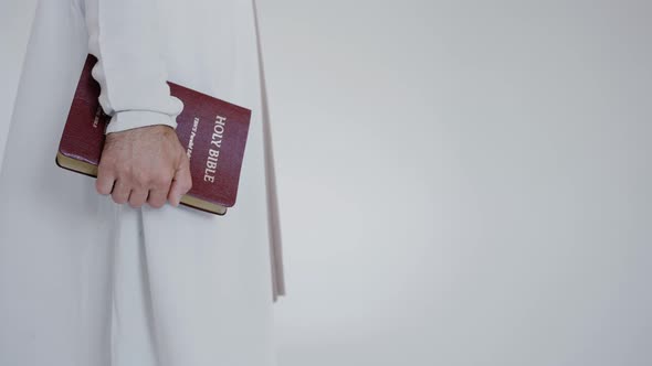 Bible in the Hand of Jesus on a White Background