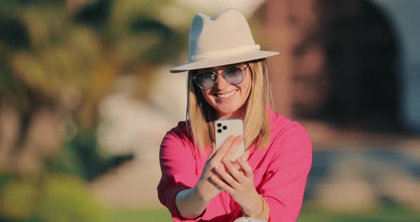  Smiling Attractive Blogger Woman in Stylish Casual Outfit Making a Selfie