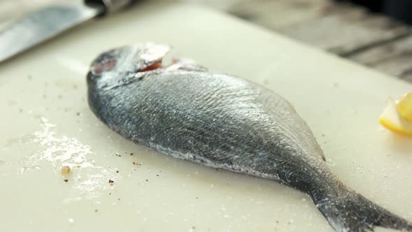 Hands Preparing Fish Close Up.