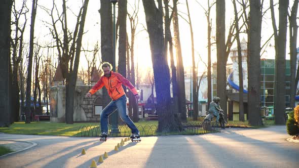 A Technical Man on Roller Skates Professionally Rides Backwards and Conducts Training in the Central