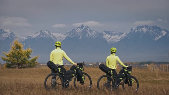 The Man and Woman Travel on Mixed Terrain Cycle Touring with Bikepacking