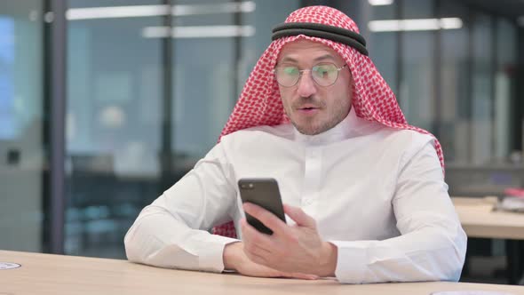 Middle Aged Arab Man doing Video Call on Smartphone in Office