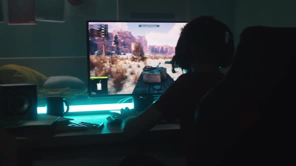 Teen Gamer Playing Tanks Videogame at Night