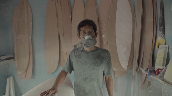 Portrait of Indonesian Craftsman in Surfboard Workshop