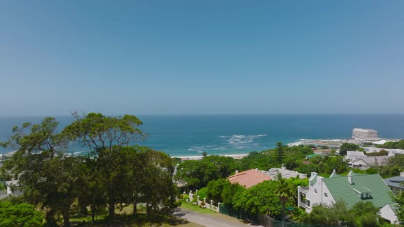 Forwards Fly Above Calm Residential Borough with Nice View of Sea