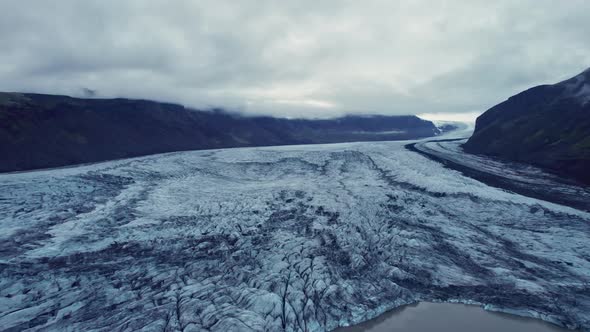 Drone Flight Pulling Back Over Glacier In Valley