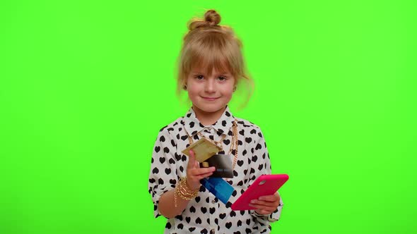 Little Teen Kid Child Girl Using Credit Bank Cards and Smartphone While Purchases Online Shopping