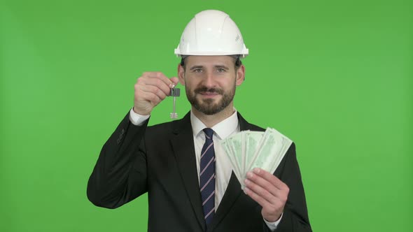 Cheerful Engineer with House Key and Money Against Chroma Key