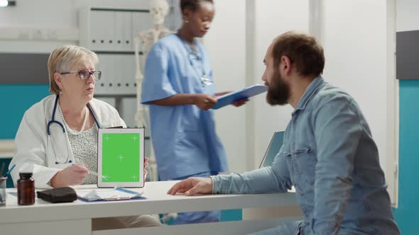 Physician and Patient Analyzing Digital Tablet with Greenscreen