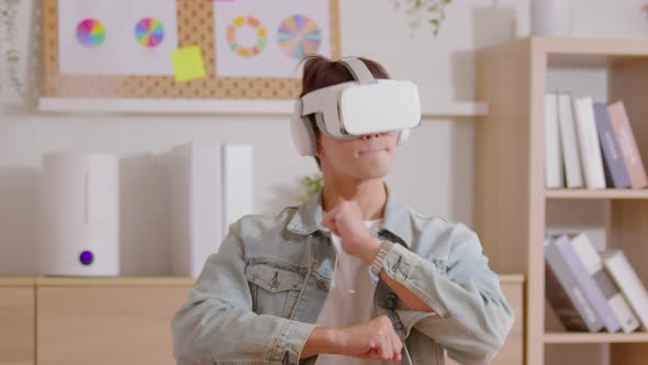 Young male uses virtual reality glasses looking learning