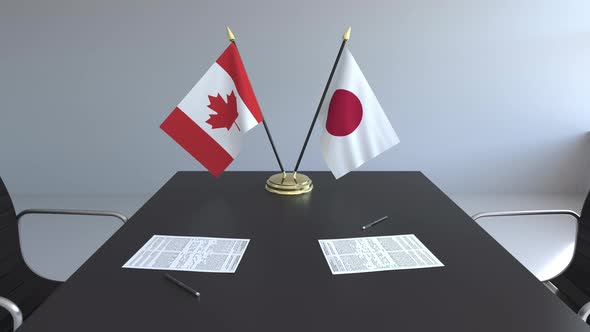 Flags of Canada and Japan on the Table