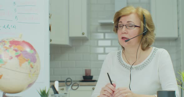 Close Up Portrait Woman Remote Teacher Online Tutor in Headphones Looks Camera Teaches Communicates