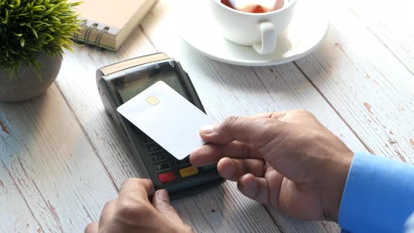 Rear View of Young Man Paying with Credit Card Contactless Payment Concept