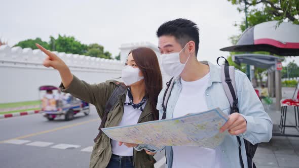 Asian romantic couple wear mask, travel in the city for honeymoon trip.