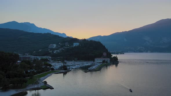 Riva del Garda yacht harbor at romantic sunrise, aerial view on haven and lake