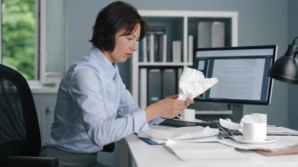 Woman Rewatching Crumpled Documents