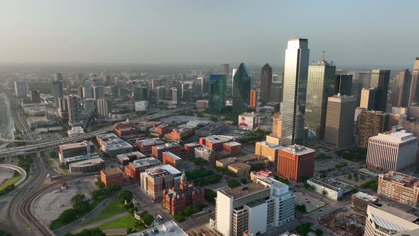 Downtown Dallas Texas skyline. Aerial pan at magic golden hour light. Sunset over Trinity River brid