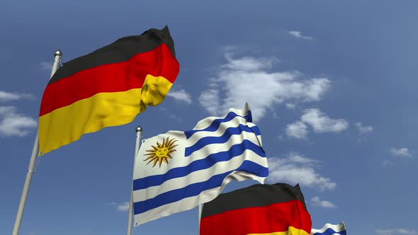 Flags of Uruguay and Germany Against Blue Sky alt