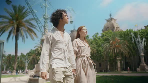 Tourist Couple Walking on Summer City Together. Happy Family Holding Hands