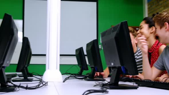 Students studying on computer in classroom