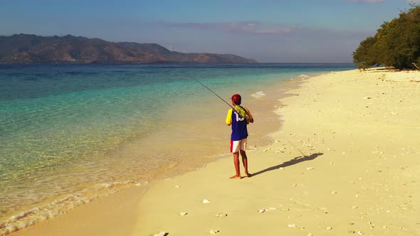 Viti Levu Island, Fiji - Young Fisherman On the Seashore Holding Fishing Tackle and Trying to catch