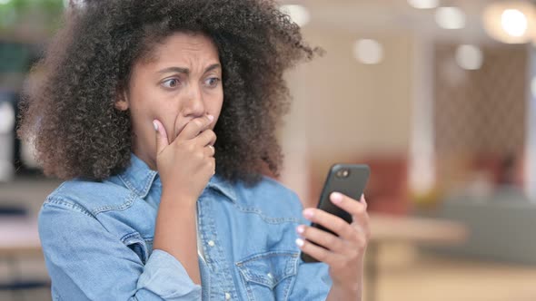 African Woman Upset By Loss on Smartphone 