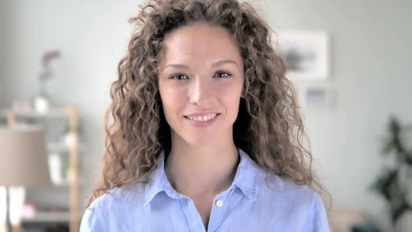 Portrait of Smiling Curly Hair Woman Looking at Camera