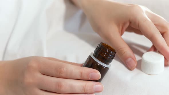 Closeup  Footage of Ill Woman Taking Out Pills From Glass Small Bottle and Drinking Them